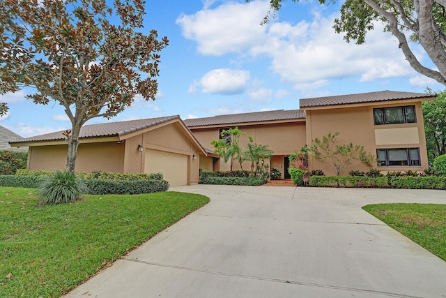 view of front of house with a front yard and a garage