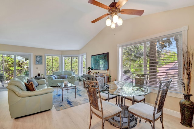 dining room featuring lofted ceiling, light hardwood / wood-style floors, and ceiling fan