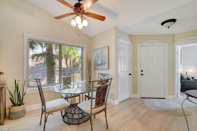 dining room with vaulted ceiling, ceiling fan, and light wood-type flooring