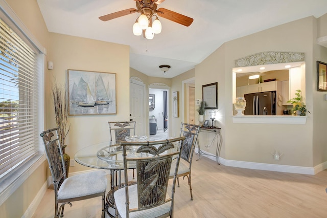 dining room with ceiling fan and light hardwood / wood-style flooring