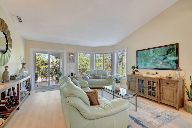 living room featuring light hardwood / wood-style flooring and vaulted ceiling