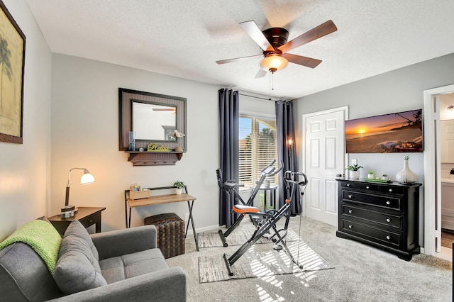 interior space with ceiling fan, light colored carpet, and a textured ceiling