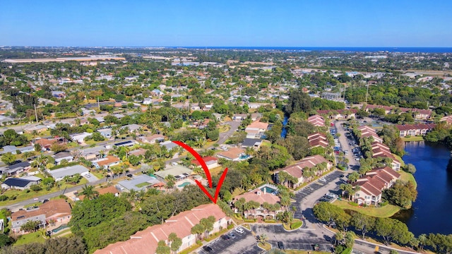 birds eye view of property with a water view