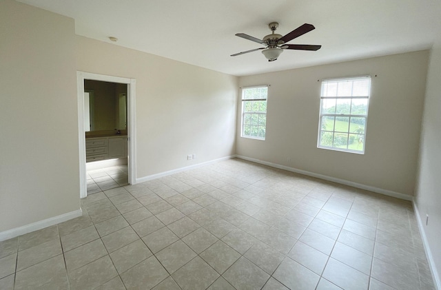 unfurnished room featuring ceiling fan and light tile patterned floors