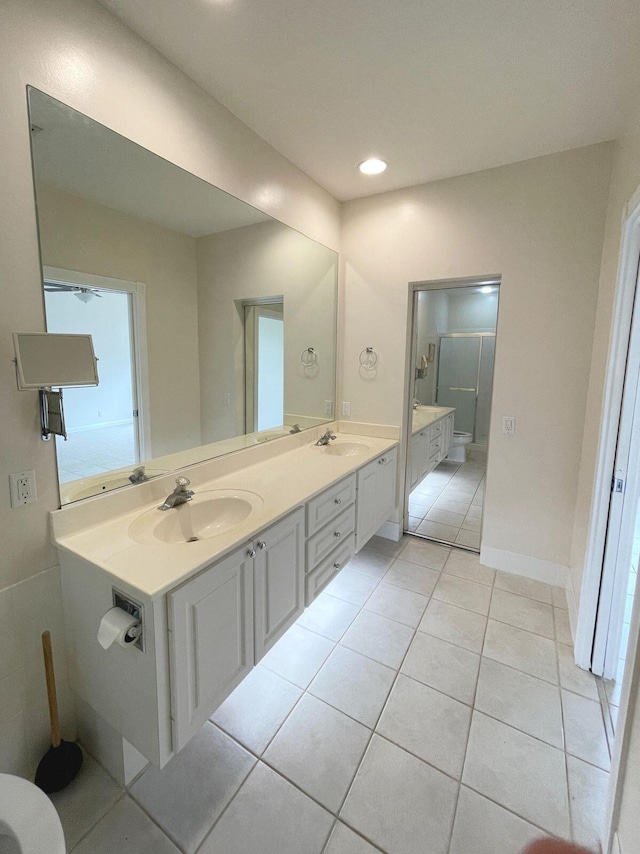 bathroom featuring vanity, tile patterned floors, and a shower with shower door