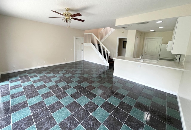 interior space with ceiling fan and sink