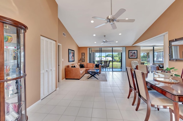 dining area featuring light tile patterned floors, high vaulted ceiling, and ceiling fan