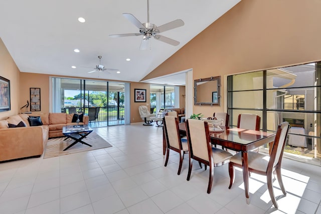 dining room featuring light tile patterned floors, high vaulted ceiling, plenty of natural light, and ceiling fan