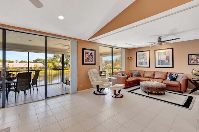 tiled living room featuring a water view, vaulted ceiling, and ceiling fan