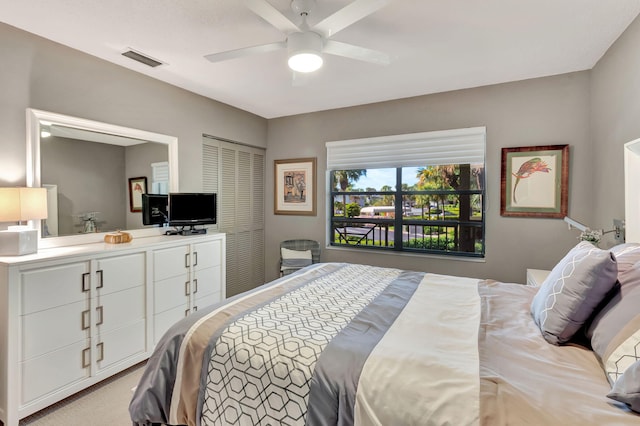 bedroom featuring ceiling fan, a closet, and light carpet