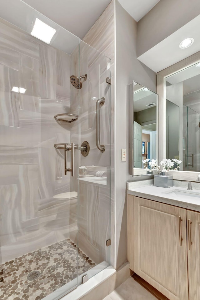 bathroom with vanity and an enclosed shower