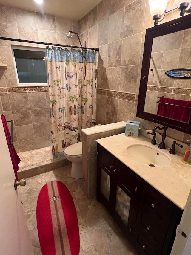 bathroom with vanity, tile walls, curtained shower, and toilet