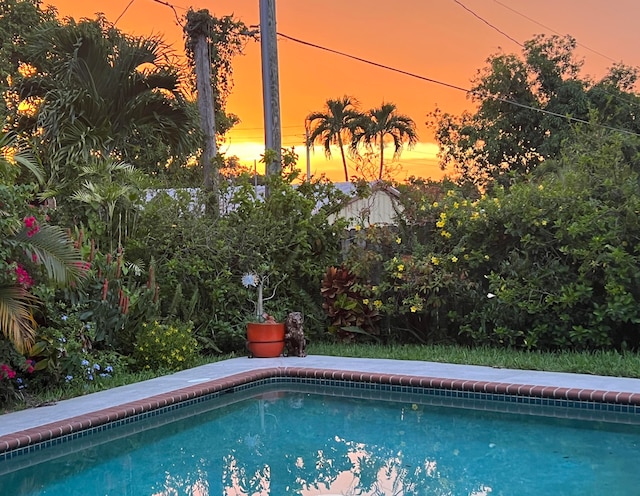 view of pool at dusk