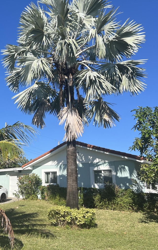 view of side of home featuring a lawn