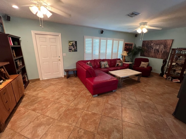 tiled living room with ceiling fan