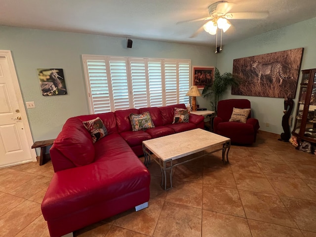 living room with ceiling fan and tile patterned flooring