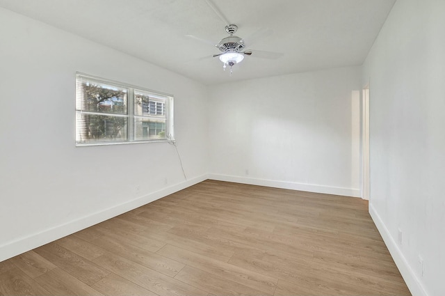 empty room with light wood-style floors, baseboards, and a ceiling fan