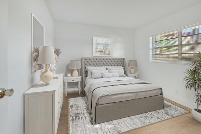 bedroom featuring wood finished floors and baseboards