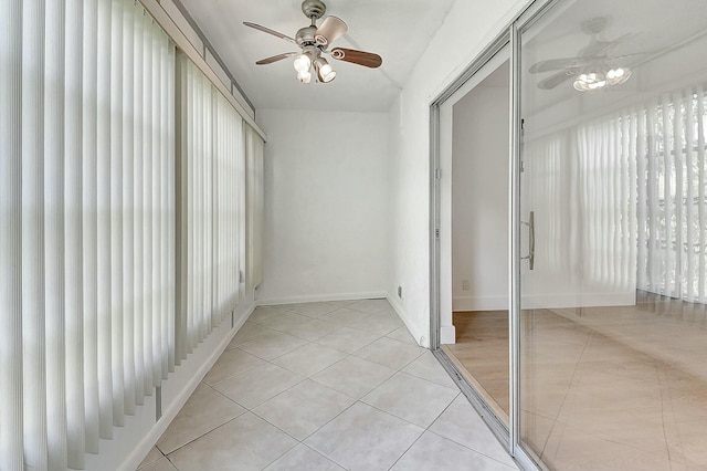 interior space with ceiling fan