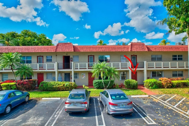 view of property featuring uncovered parking