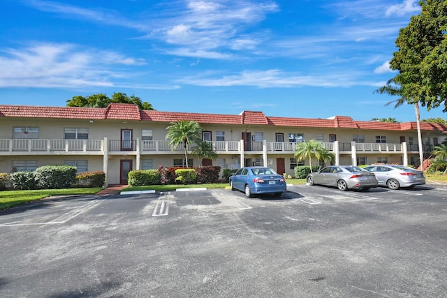 view of property featuring uncovered parking