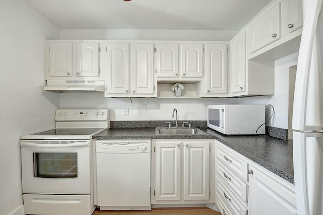 kitchen featuring under cabinet range hood, white appliances, a sink, white cabinets, and dark countertops