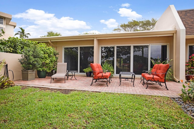 rear view of property featuring a yard and a patio