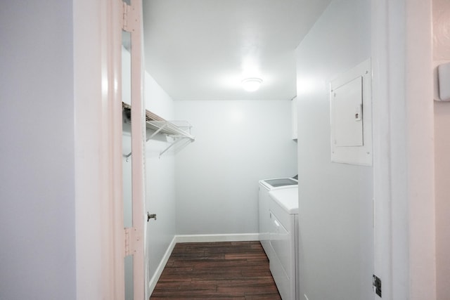 clothes washing area with dark wood-type flooring, electric panel, and washing machine and clothes dryer