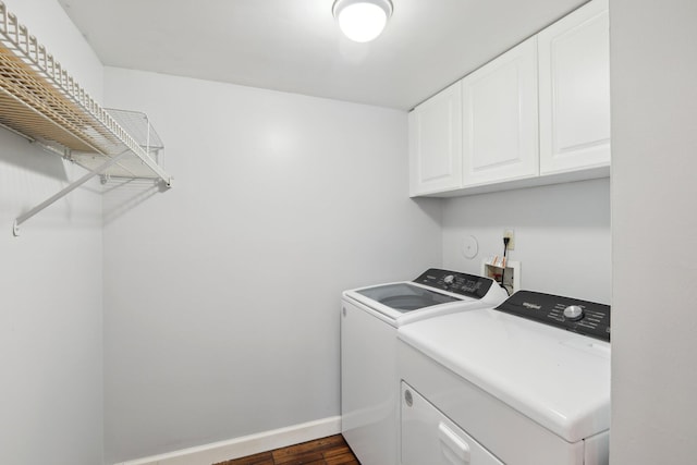 laundry room with cabinets, dark hardwood / wood-style flooring, and independent washer and dryer