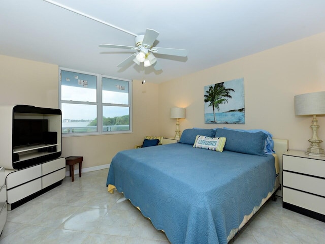 tiled bedroom featuring ceiling fan