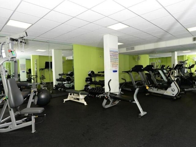 workout area with a paneled ceiling