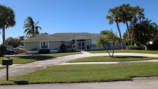 single story home featuring a front yard