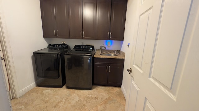 washroom featuring washer and dryer, cabinets, and sink