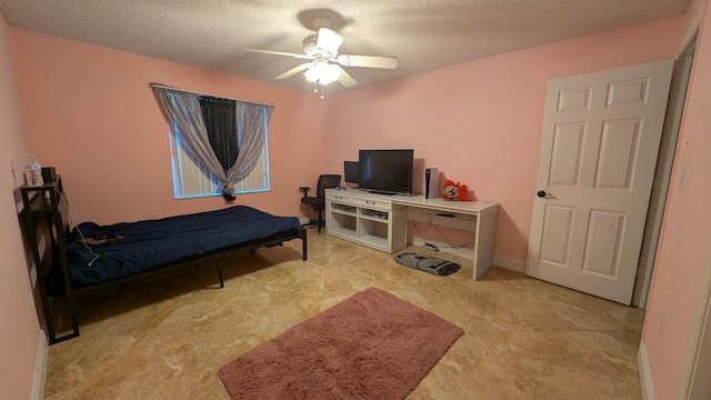 bedroom featuring a textured ceiling and ceiling fan