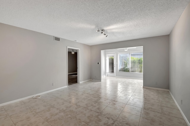 empty room with a textured ceiling