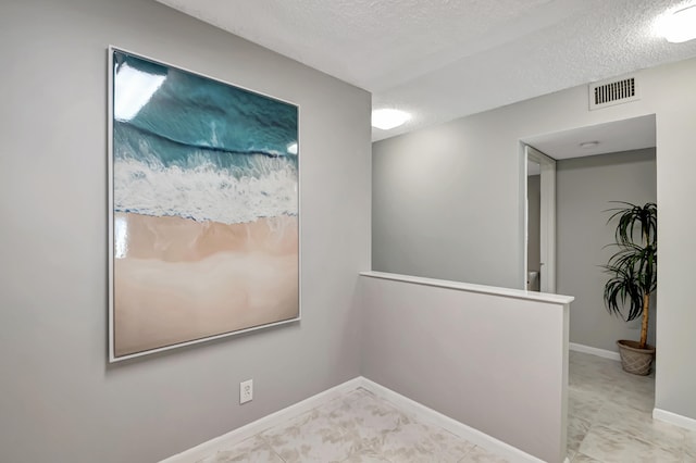 spare room featuring a textured ceiling