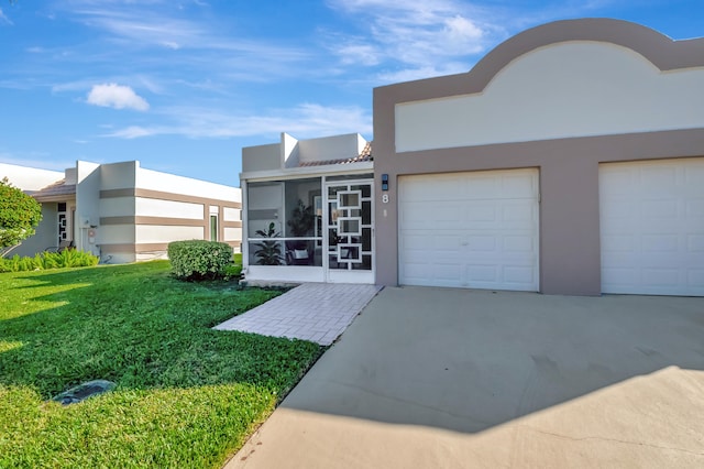 view of front of home with a sunroom and a front lawn