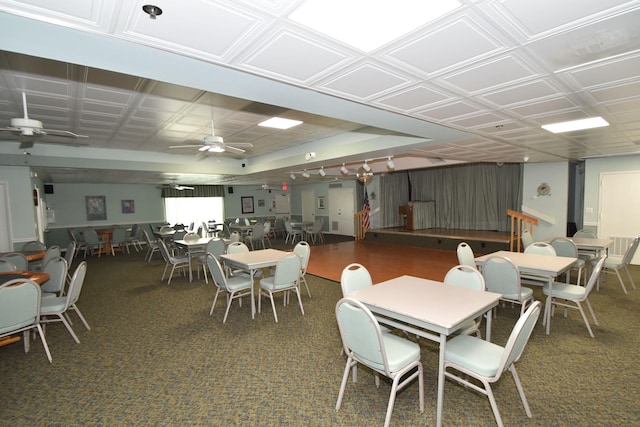 carpeted dining space with ceiling fan