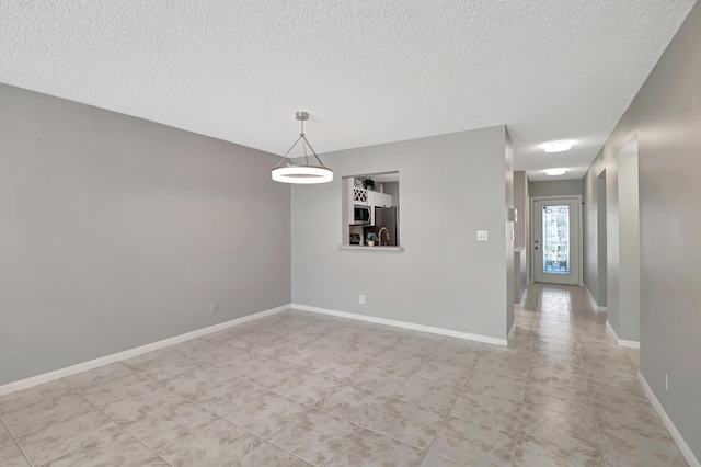 spare room with a textured ceiling