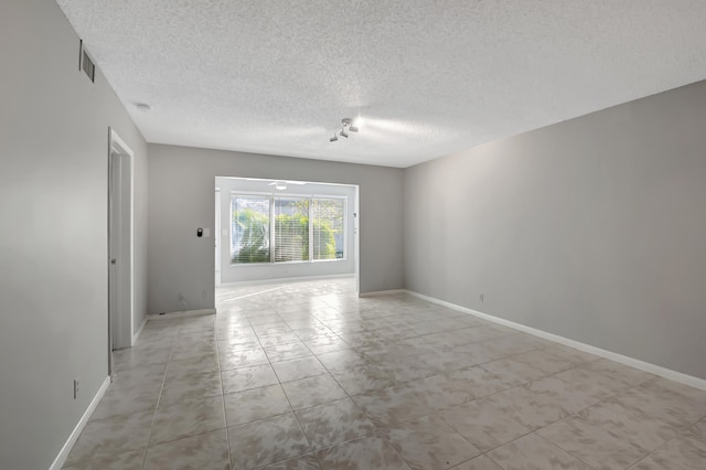 empty room featuring a textured ceiling