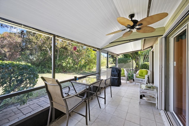sunroom featuring lofted ceiling and ceiling fan