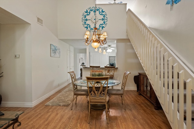 dining room with hardwood / wood-style floors and a chandelier