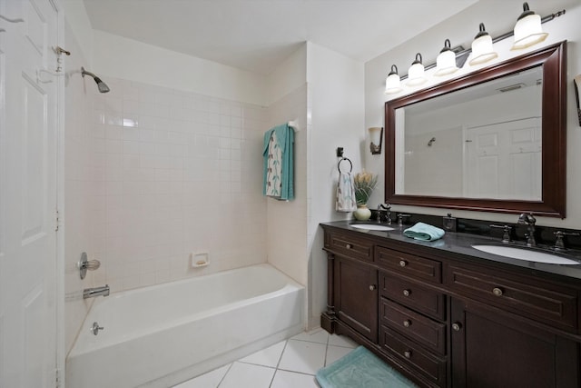 bathroom with tile patterned flooring, vanity, and tiled shower / bath combo