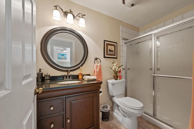 bathroom featuring tile patterned floors, vanity, toilet, and walk in shower