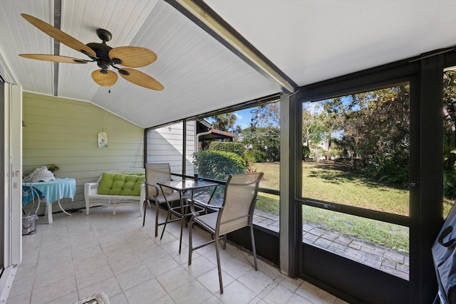 unfurnished sunroom featuring a wealth of natural light, ceiling fan, and lofted ceiling