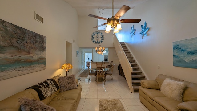 tiled living room with a high ceiling, ceiling fan with notable chandelier, and beam ceiling