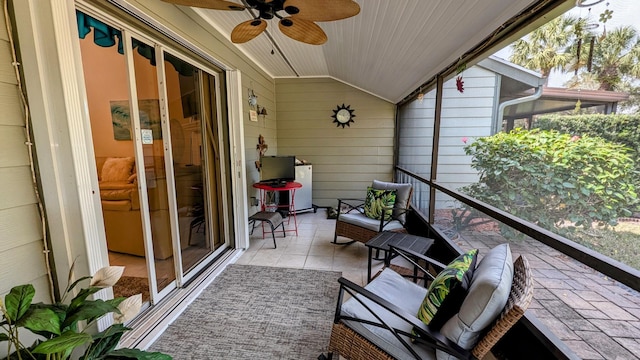 sunroom featuring lofted ceiling, a healthy amount of sunlight, and ceiling fan