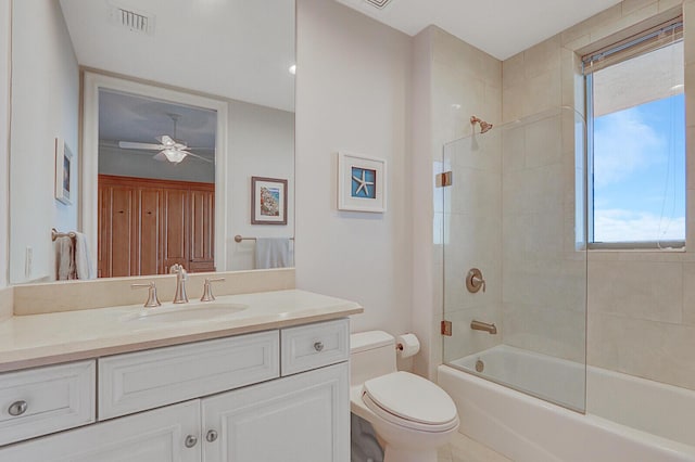 full bathroom with toilet, bath / shower combo with glass door, ceiling fan, and vanity