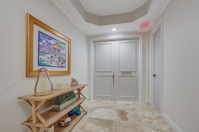 hallway with a raised ceiling