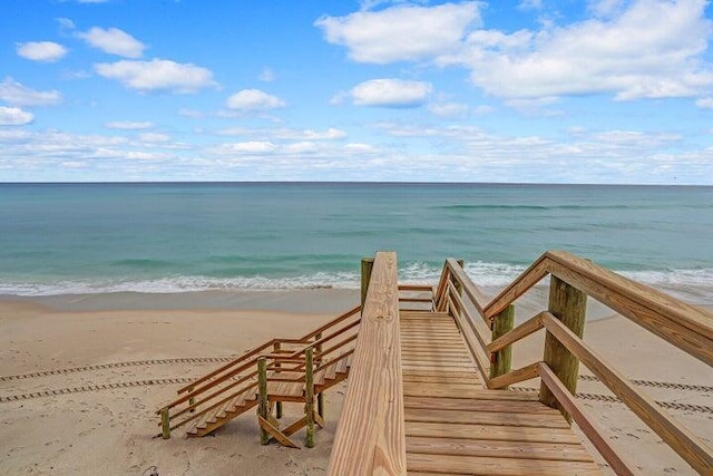 view of community featuring a beach view and a water view